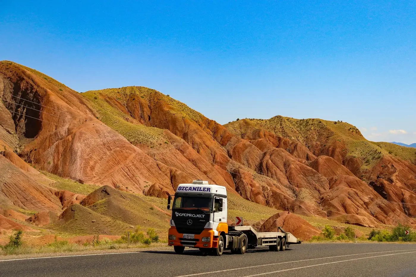 A car carrier on a desert highway