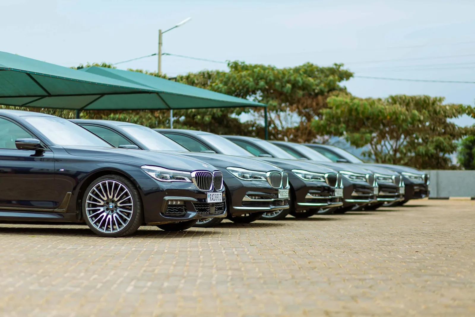 A row of cars parked under the lot canopy