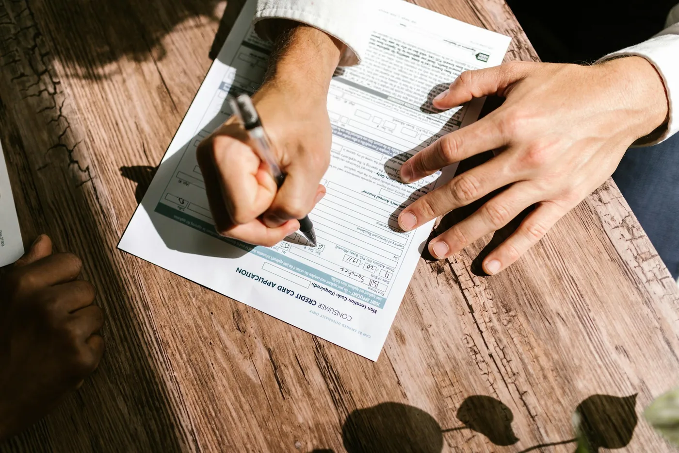 Signing the paperwork at a table